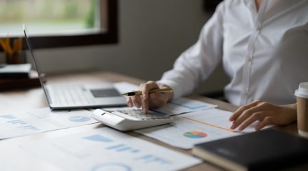 Business woman using calculator for do math finance in office, tax, accounting, statistics and